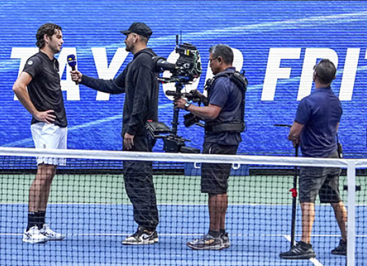 Taylor Fritz is interviewed by Nick Kyrgios after a men's singles quarterfinal match at the 2024 US Open on Tuesday, Sep. 3, 2024 in Flushing, NY. (Garrett Ellwood/USTA)